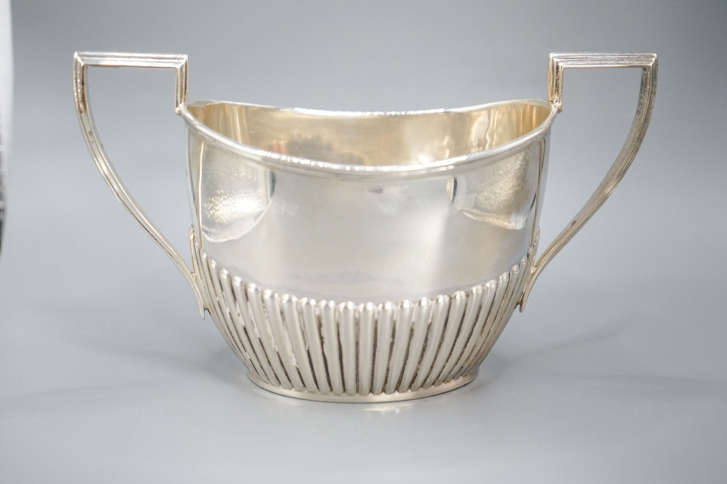 A late Victorian fluted silver cream jug and matching sugar bowl, by Walker & Hall, Sheffield, 1892/3, 13oz.